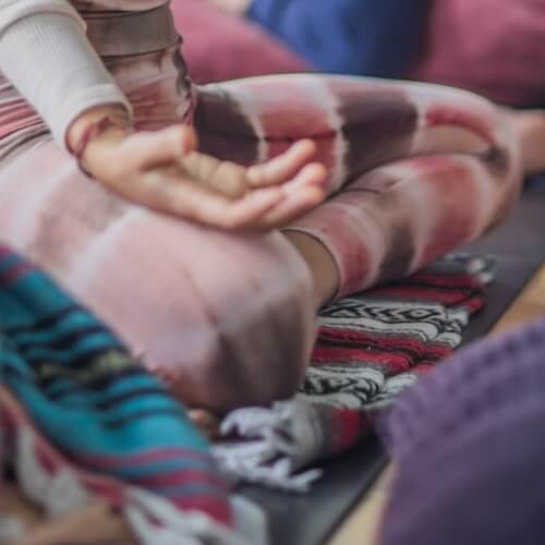 Participant seated in meditation during an Esalen yoga program in Big Sur