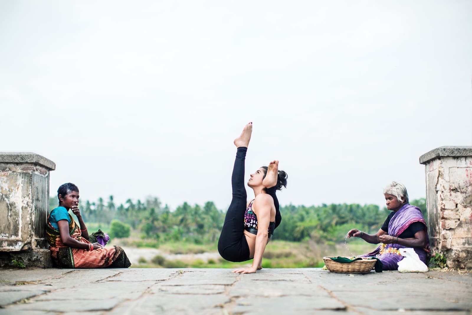 Bibi Lorenzetti demonstrating an advanced Ashtanga balance outdoors in the official retreat image